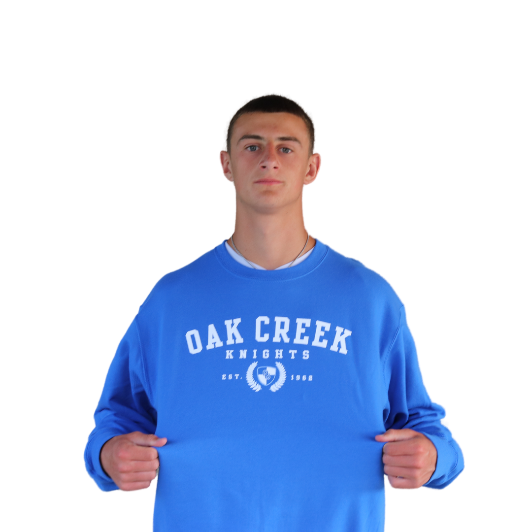 Person wearing Royal Blue Crewneck with Oak Creek Knights logo