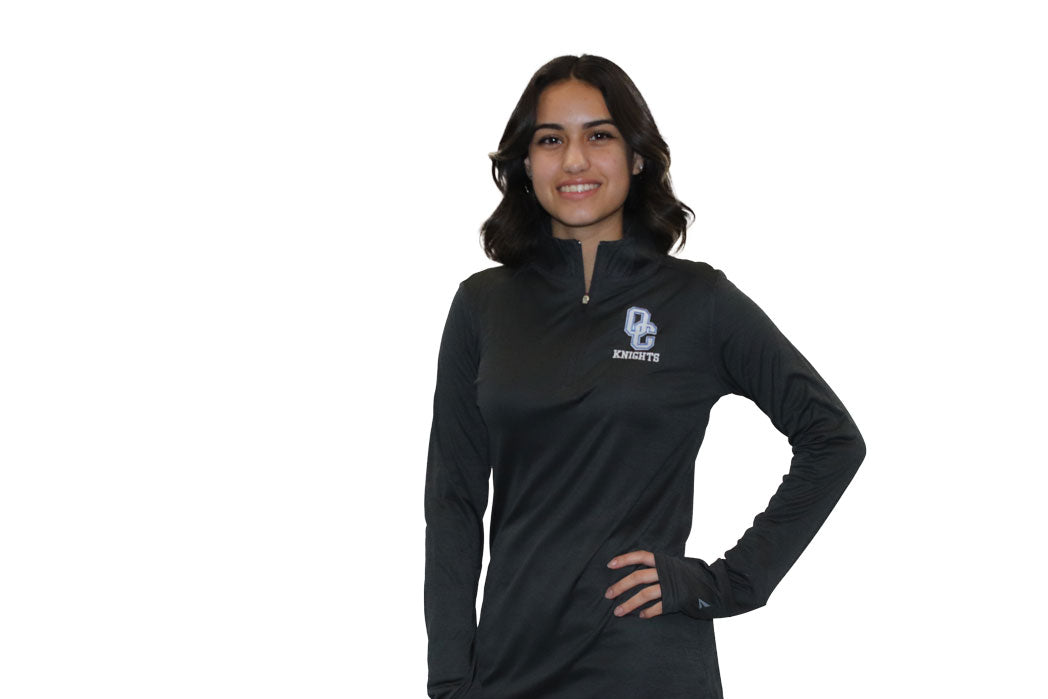 Young woman wearing a black Oak Creek Knights quarter zip.