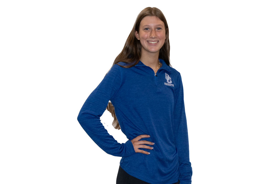 Young woman wearing a black Oak Creek Knights quarter zip.