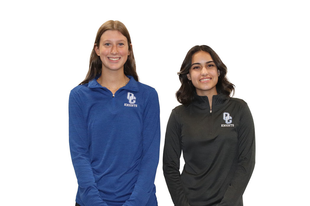 Young women wearing a black Oak Creek Knights quarter zip.