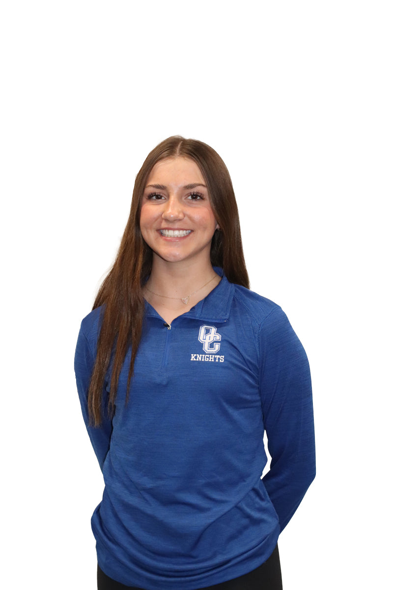 Young woman wearing a blue Oak Creek Knights quarter zip.