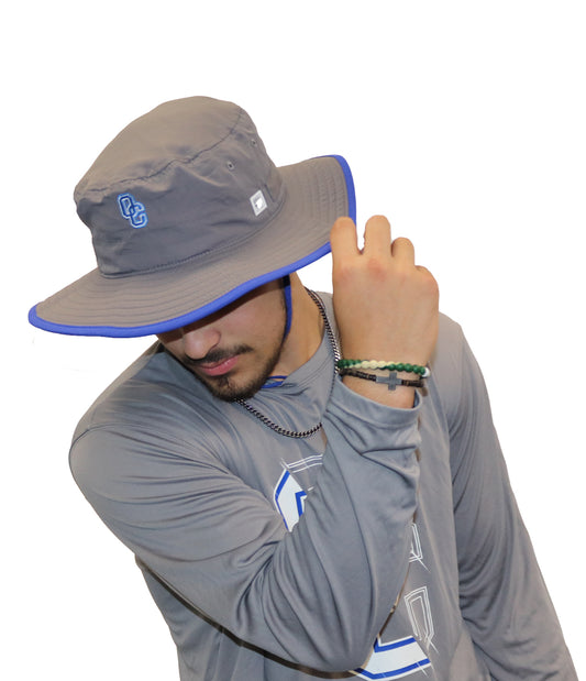 Grey bucket hat with royal blue trim with an embroidered with blue and white OC logo on front of hat.