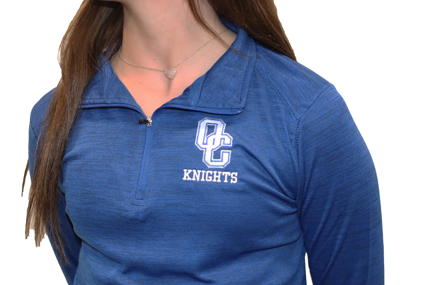 Young woman wearing a blue Oak Creek Knights quarter zip.